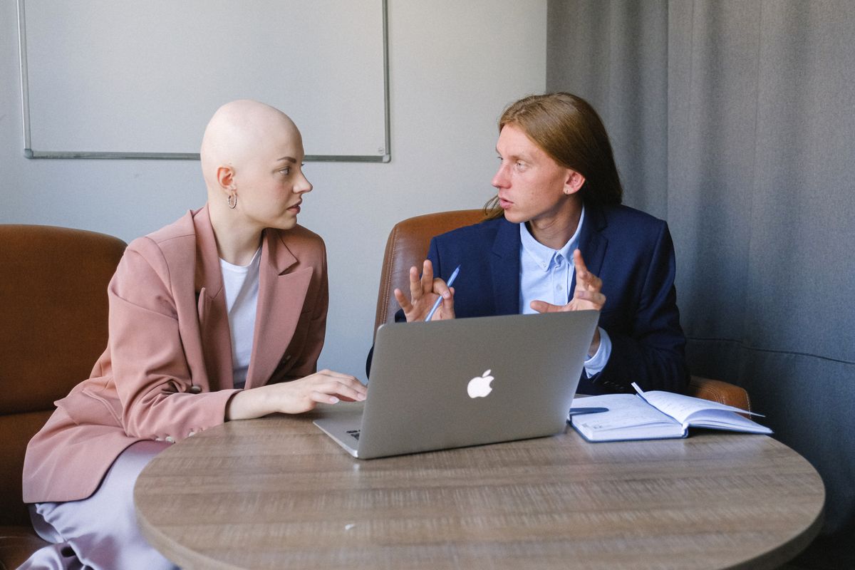 A pair reviewing records on screen