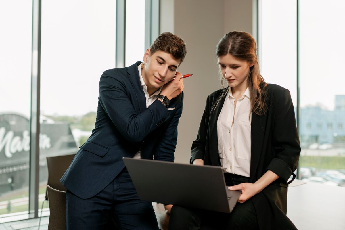 A pair reviewing records on screen